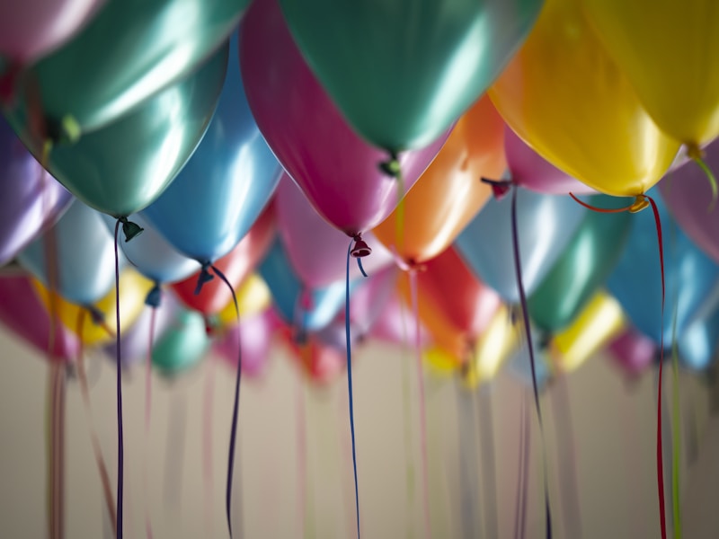 Birthday celebration with colorful balloons and cake